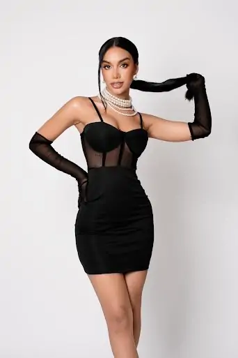 Lauren, Orgazum911 VIP escort in Mexico City, wearing a formal black cocktail dress and pearl necklace, styled for elegant private bookings